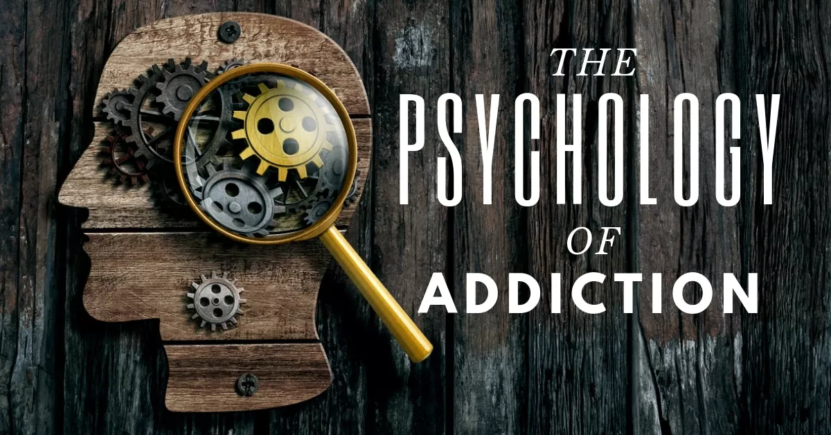A wooden silhouette of a head filled with gears, examined through a magnifying glass, titled “The Psychology of Addiction”.